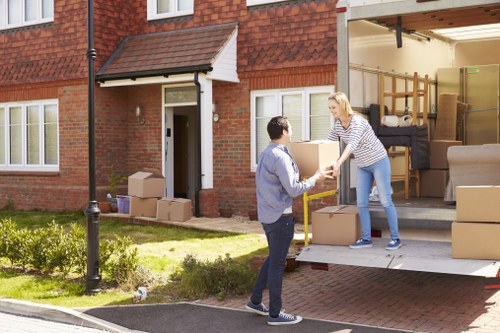 Man with van loading household items for transport