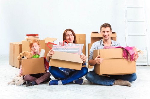Removal team handling furniture and boxes in a Coulsdon home