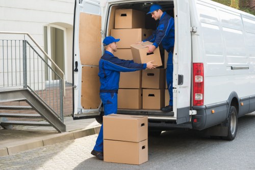 Removal van and moving team working in a Coulsdon residential street